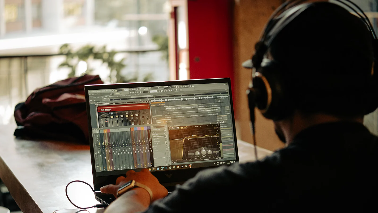 Creator wearing headphones while working with audio software